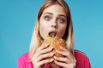 young woman eating hamburger