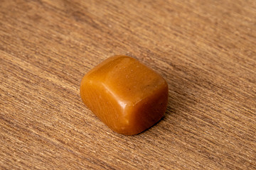 Chinese Jade gemstone luxury good yellow orange and brown tones on wooden underground