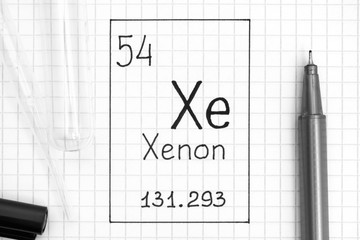 The Periodic table of elements. Handwriting chemical element Xenon Xe with black pen, test tube and pipette.