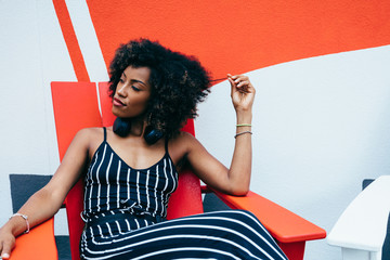 Young woman in black and white striped jumpsuit