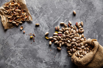 Roasted pistachios on natural wooden table background
