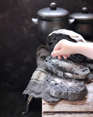 slices of black bread with the addition of activated carbon. Slices of bread with salt on a wooden table