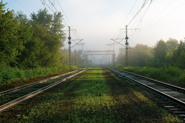railway tracks going into the fog