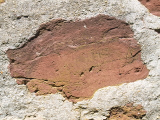 Red Sandstone  Rock in Old Stone Wall with White Mortar Close-Up