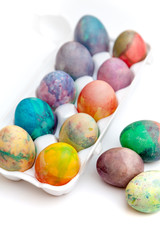 Group of Easter painted eggs in white container