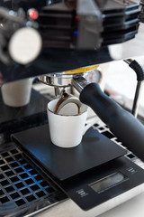 Coffee machine and barista preparing coffee in a cafe shop