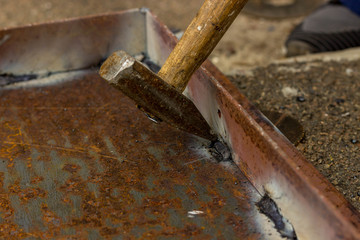 Weld seams on rusty metal. The metal corner is welded to the iron base.