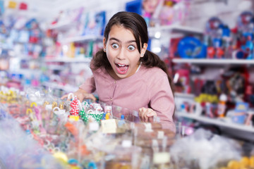 girl with open mouth buying sweet candies