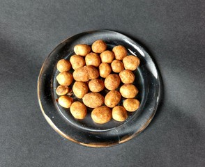 Japanese peanut served in glass dish with black background