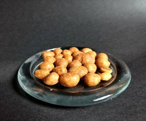 Japanese peanut served in glass dish with black background