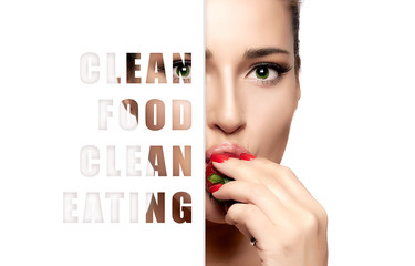 Clean food. Clean eating concept. Beautiful young woman eating fresh ripe strawberry