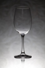 Glass wine glass stands on a blurred background