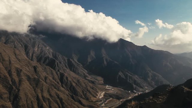 TIMELAPSE of clouds gliding over mountain range in Asir Province in Saudi Arabia. LOCKED OFF