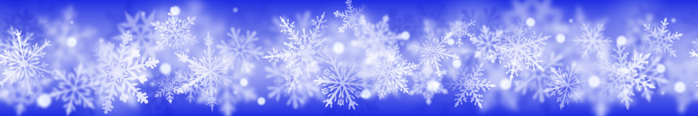 Fototapeta na wymiar Christmas banner of complex blurred and clear snowflakes in white colors on blue background. With horizontal repetition