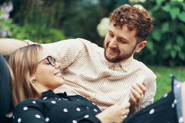 Couple in love lying on the grass in the yard of his house