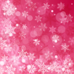 Christmas blurred background of complex defocused big and small falling snowflakes in pink colors with bokeh effect