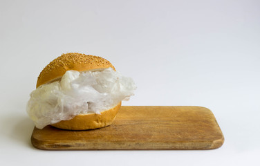 Bun with polyethylene and plastic instead of vegetables and meat. The problem of pollution of the...
