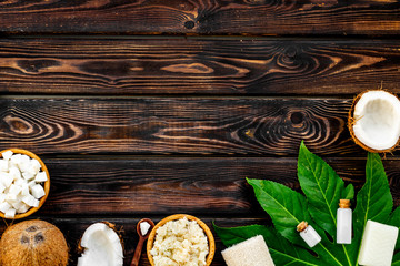 Organic cosmetics with coconut oil on wooden background top view mockup