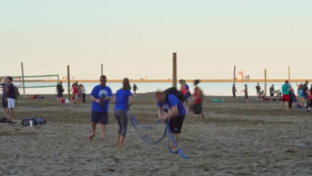 Blurry timelapse sequence of Toronto, Canada, Ontario. Woodbine Beach and Ashbridge's Bay view at the commuters and people playing volleyball on the lake. Summer evening holiday vacation concept. 4k.