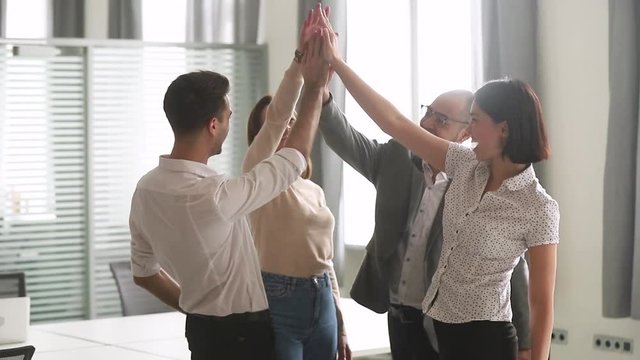Happy leader motivate diverse employees business team give high five