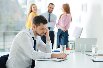 Coworkers bullying their colleague at work