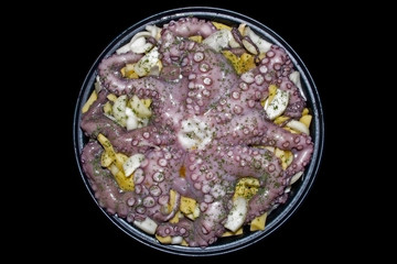 octopus with potatoes and onions isolated on black