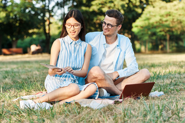 young couple sitting on bench in the park