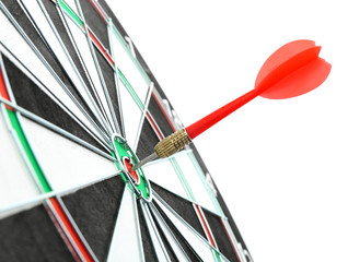 Dart board with color arrow hitting target, closeup