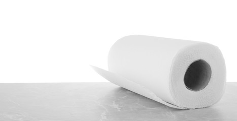 Roll of paper towels on grey stone table against white background, space for text