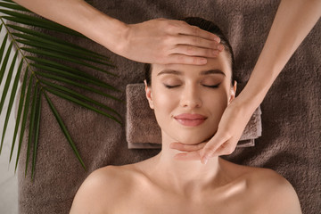 Beautiful young woman enjoying massage in spa salon, top view