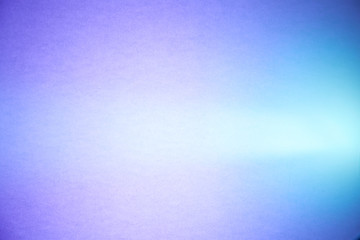 Light blue semi-blurred and purple textural background crosses the turquoise ray of light