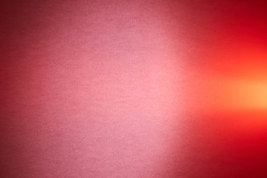 Dark pink textural and smooth red background crosses the light red beam of light
