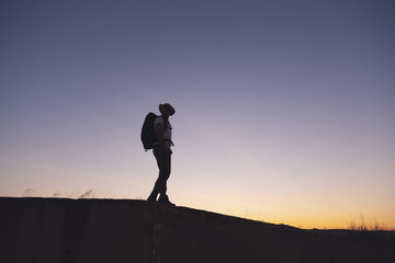 Fototapeta na wymiar backpacker traveler walking at sunrise