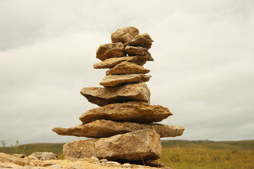 Fototapeta na wymiar Balanced stones on the alpine meadow near caucasus mountains