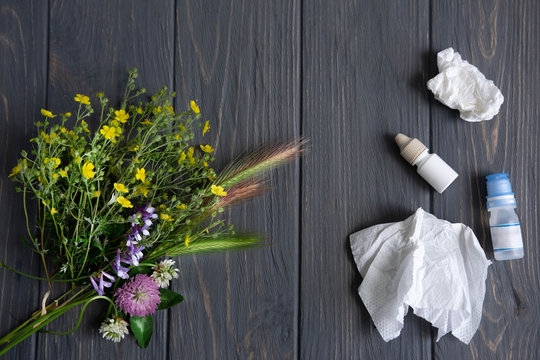Conceptual photo with wildflowers, nose drops and shawls. Allergy. Allergy drops. Seasonal allergy to flower pollen
