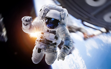 Astronaut in outer space near ISS station on orbit of the Earth. Elements of this image furnished...