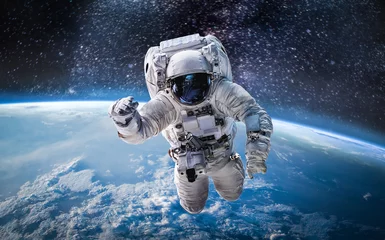 Foto op Plexiglas Jongenskamer Astronaut in de ruimte boven de planeet aarde. Abstracte behang. Ruimtevaarder. Elementen van deze afbeelding geleverd door NASA