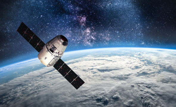 Cargo space ship on orbit of the Earth planet. Milky way on background. Elements of this image furnished by NASA - Powered by Adobe