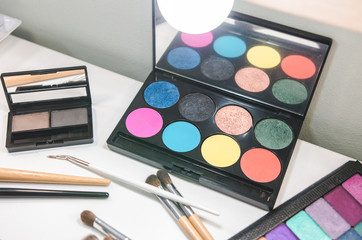 Beauty tools palettes collection. Brush on white table