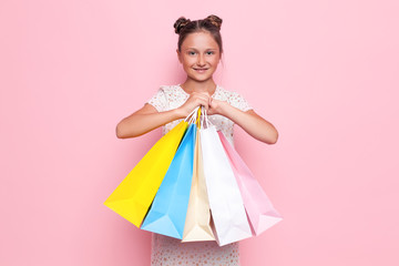 girl in stylish dress, teenager with purchases in hands, after shopping trip
