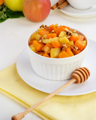 Juicy roasted pumpkins and apples with walnuts filling, food background