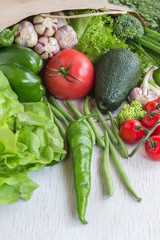 Healthy food in paper bag of different  vegetables on white background. Top view.