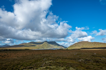 View across a boggy landscape to distant hills, Connemara, County Galway