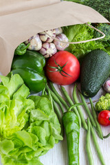 Healthy food in paper bag of different  vegetables on white background. Top view.