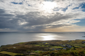 Fototapeta na wymiar Sun reflecting on Atlantic ocean, view from the Sky Road, near Clifden, Galway, Ireland