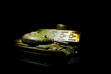 Old green metal children toys in a ray of light. Soviet toys. Military equipment. - 279033175
