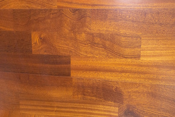 Parquet made of natural hardwood with a glare of sunlight.