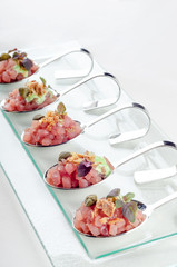 Top view catering banquet table with cold snacks. Raw tuna Tartare decorated capers, close up. Dishes in the restaurant. easy food for guests. Party food.