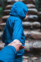 Little boy holding his fathers hand