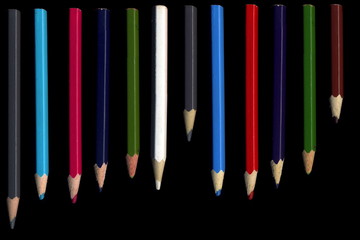 Old colored pencils lying on a black background - 279034527